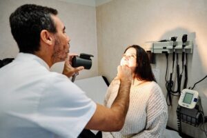 A man is taking pictures of a woman 's face.